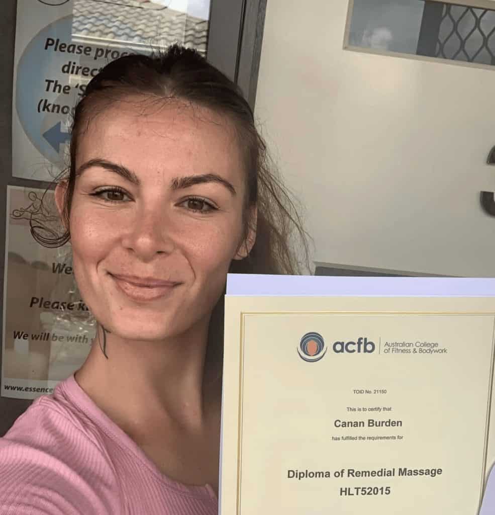Canan Burden holding her Diploma of Remedial Massage from the Australian College of Fitness and Bodywork