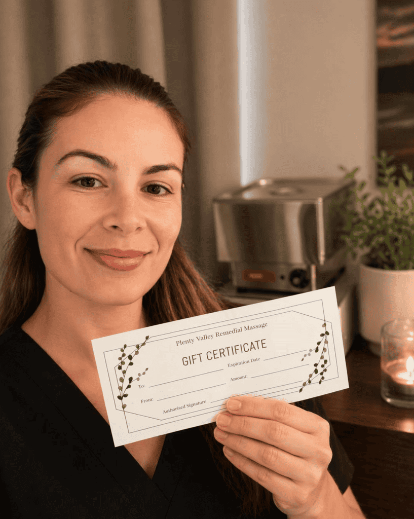 Canan Burden, Remedial Massage Therapist at Plenty Valley Remedial Massage, holding a gift certificate